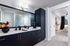 Midnight blue cabinetry and stylish pendant lighting