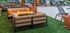 Luxurious outdoor seating area with a fire pit, surrounded by cozy chairs, on lush green grass, perfect for relaxation and entertainment.