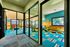 Bright and colorful children's playroom with engaging play structures, vibrant decor, and large windows for natural light, perfect for family-friendly living.
