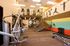 Bright and modern gym with top-of-the-line fitness equipment, vibrant mural art, and sleek mezzanine fitness area.