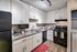 Modern kitchen with sleek black appliances, stylish countertops, and elegant cabinetry, ideal for gourmet cooking in a cozy home setting.