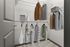 Spacious walk-in closet showcasing organized hanging spaces with stylish clothing and accessories, ideal for fashion enthusiasts.