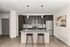 Modern kitchen with sleek dark cabinetry, stainless steel appliances, and a stylish granite countertop island with seating for two.