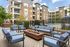 Chic urban courtyard with modern seating and fire pit overlooking a stunning pool area.