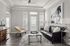 Elegant living room with a stylish black leather sofa, artistic horse painting, and abundant natural light from large windows and glass door.