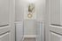 Sleek and modern laundry room with front-load washer and dryer, complemented by minimalist art and soft lighting.