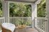 Charming balcony with cozy seating and lush green views, perfect for serene relaxation.