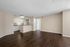 Bright and spacious living area with elegant wood flooring, open kitchen with modern appliances, and welcoming ambiance.