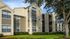 Charming apartment complex showcasing modern architecture, lush green landscaping, and vibrant exterior design.