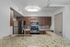 Elegant modern kitchen with sleek granite countertops, stylish stainless steel appliances, and rich wooden cabinetry.