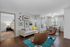 Charming open-plan living room with stylish decor, cozy bedroom view, elegant dining area by large sunlit windows, featuring modern art and colorful accents.