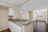 Inviting open-concept living space with a modern kitchen featuring sleek countertops, elegant cabinetry, and ample natural light.
