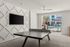 Bright recreation room featuring a ping pong table, stylish wall design, and view of an outdoor pool area.