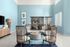 Modern lounge with stylish wooden chairs, artistic decor, and a calming blue palette.