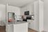 Contemporary kitchen with granite countertops, stainless steel appliances, and white cabinetry.