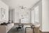 Contemporary living room with modern beige sofa, stylish coffee tables, and chic wall art.