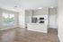 Bright and airy open-plan kitchen and living area with sleek stainless steel appliances, modern cabinetry, and inviting hardwood floors.