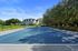 Bright, well-maintained tennis court with scenic views and lush surroundings, perfect for sports enthusiasts.