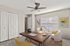 Chic home office with a sleek wooden desk, modern decor, and abundant natural light.
