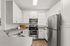 Modern kitchen featuring sleek white cabinetry and stainless steel appliances, perfect for culinary creativity.