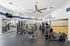 Modern fitness center with state-of-the-art equipment, mirrored walls, and motivational quotes, perfect for an energetic workout.