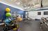 Modern fitness center with stylish exercise bikes, vibrant yoga balls, and advanced strength training equipment, in a brightly lit space.