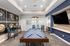 Chic recreation room featuring a stylish pool table, modern artwork, and a comfortable seating area, perfect for entertainment and relaxation.