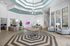 Inviting lobby with modern design, featuring stylish seating, vibrant decor, and a striking geometric floor pattern.