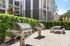 Two Stainless steel grill outdoors on a patio area with a picnic table