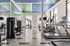 Indoor fitness center with tiled flooring, treadmill, ellipticals, and weight machines