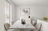 Furnished dining area with dining table, window, and view of kitchen island