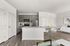 Furnished kitchen with extended kitchen island, stainless steel appliances, built in pantry, and light gray cabinets