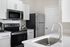 Contemporary kitchen with stainless steel appliances, sleek countertops, and modern fittings.