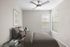 Bright and cozy bedroom with neutral-toned decor, featuring a plush bed and stylish ceiling fan.
