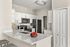 Modern kitchen with sleek white cabinets, elegant countertops, and contemporary appliances creating an inviting cooking space.