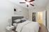 Inviting bedroom featuring a cozy bed, elegant decor, and a well-organized walk-in closet.