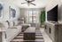 Modern living room with a plush sectional sofa, elegant decor, and a large flat-screen TV. Sunlit space featuring stylish wall art and a vibrant green plant, offering a cozy and inviting atmosphere.