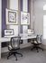 Modern workspace with dual computer stations featuring sleek chairs and artistic wall decor, ideal for productivity and creativity.