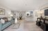 Contemporary open-concept living and dining area with elegant furnishings, plush seating, modern kitchen, and decorative accents.