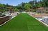 Charming outdoor recreation area featuring a lush green lawn, stylish pergolas, and inviting seating spaces with vibrant umbrellas.