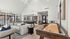 Bright and modern recreational room featuring cozy seating, pool and shuffleboard tables, with large windows overlooking a stylish patio area.