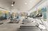 State-of-the-art fitness center with modern treadmills, weight stations, and lush outdoor views.