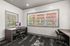 Bright home office space with modern desk, ergonomic chair, and large windows offering scenic outdoor views.
