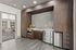 Contemporary kitchen with sleek dark wood cabinetry, stainless steel appliances, and modern tile flooring, opening onto a stylish living area with ample natural light.