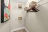 Sleek walk-in closet with modern shelving and tasteful wicker baskets, perfect for organized living.