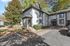 Charming townhouse with modern architecture, surrounded by lush greenery and ample parking space, set in a serene neighborhood.