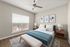 Elegant bedroom featuring a cozy double bed with plush pillows, stylish wall art, and ample natural light from a large window, perfect for a serene retreat.