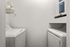 Sleek and efficient laundry nook featuring modern washer and dryer set with stylish shelving.