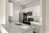 Modern kitchen with sleek quartz countertops, stainless steel appliances, and stylish cabinetry.