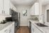 Modern kitchen with sleek stainless steel appliances, elegant white cabinetry, and polished granite countertops.
